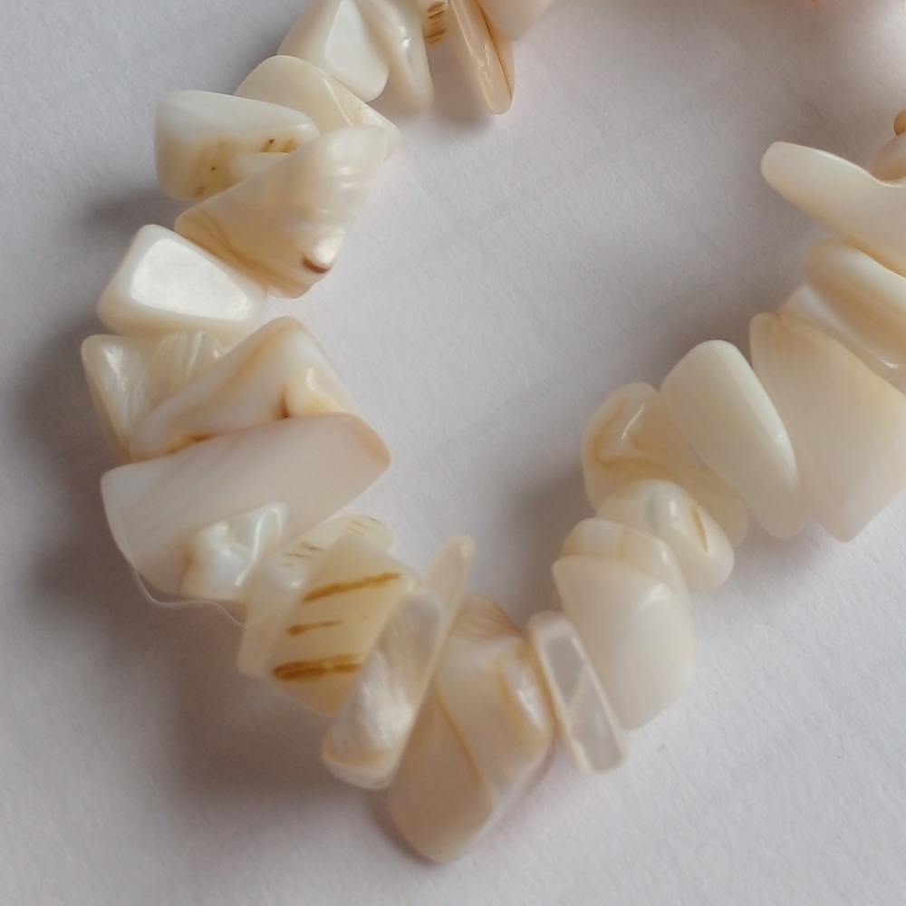 Coral shell stretchy bracelet cream white tan in color